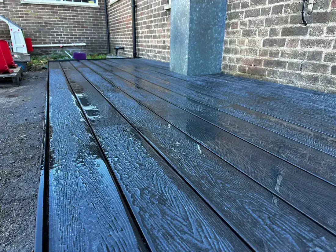 Close-up of dark composite decking boards on the same platform