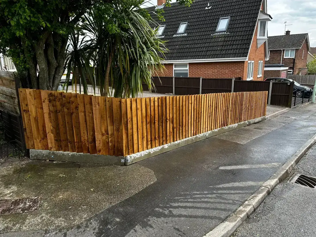 Finished timber boundary fencing beside a property